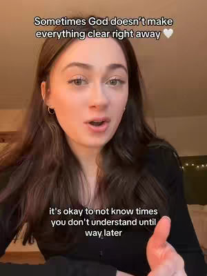 A young woman with long brown hair is shown in a selfie-style shot, looking directly at the camera with a soft expression. Text overlays are placed above and below her face. The background is blurred, with warm lighting suggesting an indoor setting.
