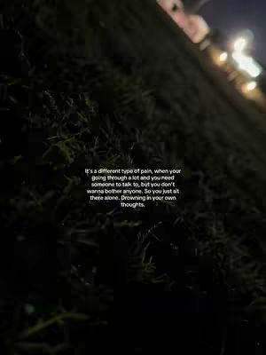 The image is a dim, nighttime scene featuring a grassy hill on a diagonal slant, with dark green foliage dominating the foreground. Text is overlaid, positioned centrally, and rendered in white against the shadowy background, contributing to a melancholic mood.