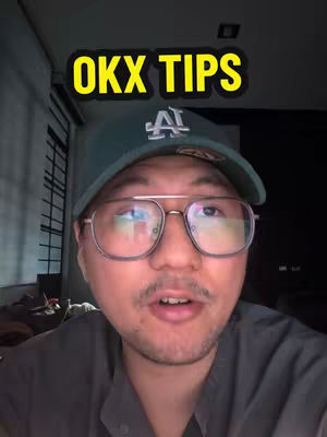 A selfie-style video cover featuring a man wearing a cap and glasses, with "OKX TIPS" in a yellow outlined text box. The background is dark, and the man appears to be speaking to the camera.