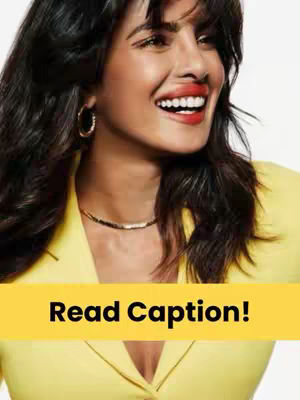 A close-up of a woman with dark hair and red lipstick, smiling. She is wearing a yellow blazer and gold earrings.