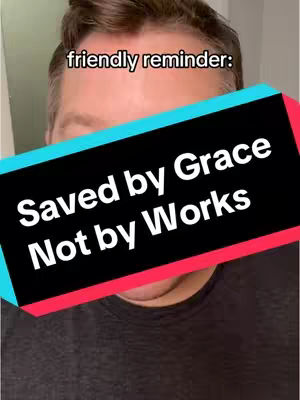 A man's face fills the frame with a black and colored banner overlay. The banner text reads 'Saved by Grace Not By Work' in a bold white font over a black background.