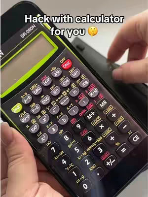 A close-up shot of a black calculator with white and grey buttons is held at an angle, partially obscuring the screen. The background is blurred, with a hand partially visible, suggesting someone is interacting with the calculator. Overlaid text reads 'Hack with calculator for you' with a surprised face emoji.