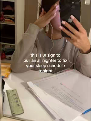 A person is taking a selfie in a bedroom with the camera pointed at a mirror. The person's face is partially obscured by a phone that covers much of their face. The text overlay reads “this is ur sign to pull an all nighter to fix your sleep schedule tonight”.