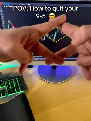 The image shows a person's hands forming a diamond shape in front of a computer monitor. The monitor displays a stock chart. A keyboard, a mousepad, and part of the desktop are in the foreground. The text overlay says, "POV: How to quit your 9-5 ".