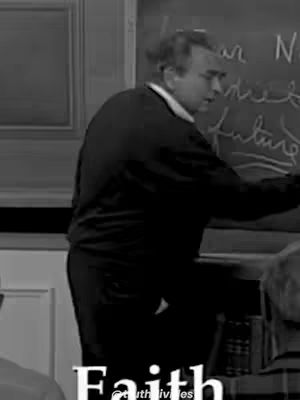 A grayscale image shows a man, dressed in a dark sweater and white collared shirt, standing in front of a chalkboard. He's positioned at an angle, appearing to write on it. The bottom of the image contains the word "Faith" in a readable font.