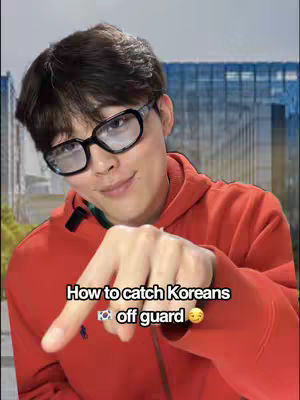 The cover image shows a young man with dark hair and glasses pointing a finger toward the viewer. He is wearing a red hoodie. Text at the bottom reads "How to catch Koreans off guard," with a Korean flag emoji and a smiling face emoji.