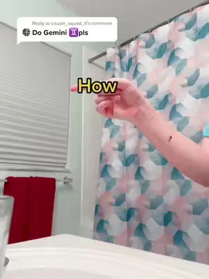 A person points towards the text 'How' that's added to the image. The person is in what looks to be a bathroom, with a shower curtain and a towel.
