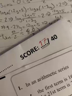 A close-up shot of a test paper with handwritten math equations and an exam score marked on it. The paper is white, and the handwriting is in blue or black ink. In the foreground, a section of the paper shows the score '17 40' in bold print, suggesting the video content is about academics or study results.