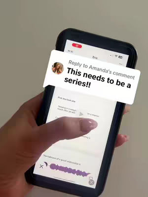 A hand holds a black smartphone with a white speech bubble overlaying the screen. The speech bubble contains text and a profile picture. The phone is held against a light-colored, possibly neutral background. The person's manicured nails are visible.