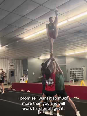 A cheerleader is held up in a stunt with one leg extended in the air. Others support the base of the stunt. Text overlays the bottom of the image.