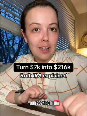 A woman with fair skin is centered in the frame, looking directly at the viewer and speaking. She has light brown hair and is wearing a patterned blouse. A black rectangle near her face has text on it and below it another black rectangle with text. The background includes a window with white blinds and some of the outdoors is visible.