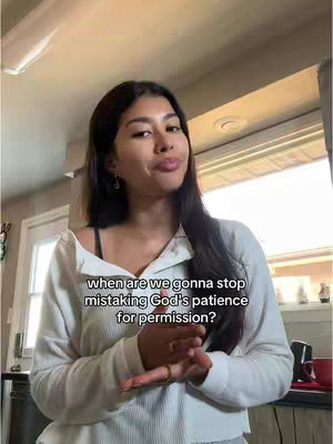 A woman with long dark hair and a white sweater is the main focus. Text overlayed on top reads, "when are we gonna stop mistaking God's patience for permission?" She is in an indoor setting with a window and doorway in the background. The overall lighting is neutral.
