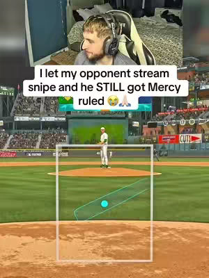 The image is a split screen. The top half shows a man with headphones in a room with messy bed and gaming setup with a video game being played. The bottom half shows gameplay from a baseball game, specifically a baseball field with a batter up to bat and graphics.