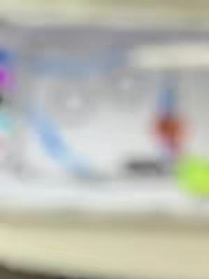 An out-of-focus image with a blurry background and a few indistinct areas of color, including blue and green.