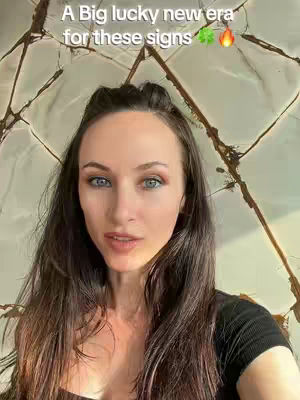 A woman with long brown hair and blue eyes looks directly at the camera. She is wearing a black top. Above her head is text against a background of a decorative surface with a marbled effect.