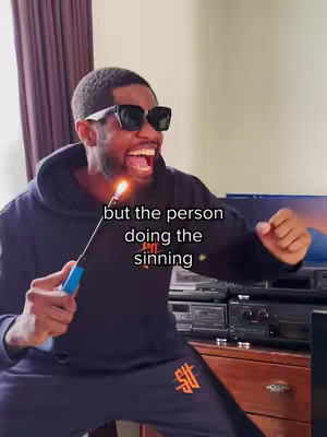 A man in a dark hoodie and sunglasses holds a lighter with a flame, looking excited with his mouth open. Text 'but the person doing the sinning' is superimposed on the image.