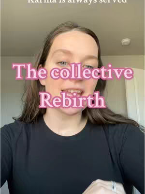 A medium shot features a young woman with long brown hair, looking directly at the camera with an open mouth. Above her is a text overlay in a pink, bubble-style font that reads 'The collective' on one line and 'Rebirth' on the next. The background is a blurred, neutral-toned room, with hints of a white wall and some light fixtures visible. She is wearing a black crew neck shirt, a ring is visible on her finger. The overall composition centers on the woman, with the text overlay drawing immediate attention.