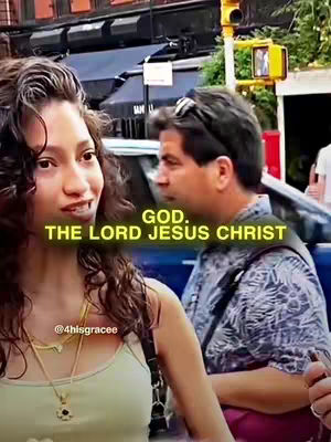 A woman is in the foreground, captured from the chest up. She has dark hair and is wearing a light-colored tank top and a necklace. Behind her, another person, a man, is slightly visible. There's a street scene with cars and buildings in the background, and the color tones are slightly muted, reflecting an urban environment. Overlay text in yellow adds context.