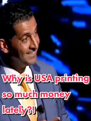 A man in a dark suit with a yellow tie is speaking. Above him, text laid overtop of him asks “Why is USA printing so much money lately?!”. The background is a blurred blue.