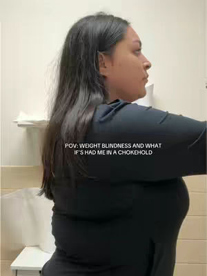 The cover image features a side profile of a woman with long, dark hair. She is wearing a black top, and her body is facing toward the right side of the image. The background is a neutral wall with a hint of fixtures visible. Text overlay at the bottom says 'POV: Weight Blindness and What If's Had Me in a Chokehold.