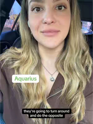 A woman with fair skin, wavy blonde hair, and brown eyes is centered in a close-up shot. She wears a brown top and a silver necklace. A rectangular green box labeled "Aquarius" sits in the top half of the frame, and a black box with white text is at the bottom.