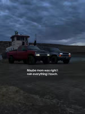 Two trucks are side-by-side on a road or similar surface, with a sky filled with heavy clouds dominating the background. The text overlay suggests a reflective or self-deprecating sentiment.