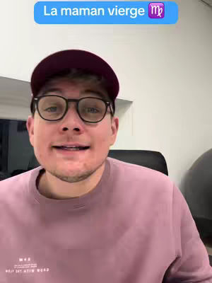 A close-up shot features a man wearing glasses and a cap, positioned against a muted background. A text overlay at the top reads 'La maman vierge' (The Virgo mother), accompanied by the Virgo zodiac symbol.