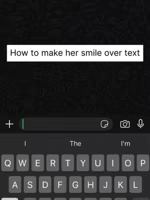 The image shows a phone screen with a text message interface. At the top, a white box contains the text: 'How to make her smile over text'. Below this, the message input field is visible, with a plus sign, an input text area, and camera and microphone icons. The keyboard is partially visible at the bottom, displaying common keys.