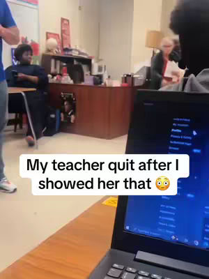 A person filming a laptop screen in a classroom setting. The foreground is a close-up of a laptop displaying a screen of options, the background is blurred, the other people in the room are hard to distinguish. A white text overlay is added at the bottom of the image.