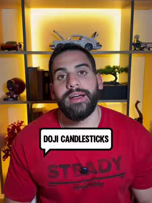 A man with a beard wearing a red t-shirt is centered in the frame, against a background of wood shelving stocked with collectibles and a warm light.