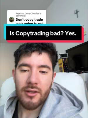 A selfie-style video cover features a man with dark hair and stubble. He is positioned in front of a neutral-colored background, likely a wall, with a comment overlay at the top from another user. Below the image is a colored banner with a question about copytrading.