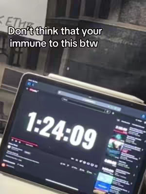 The image shows a tablet displaying a black screen with white numbers indicating time. Overlayed text at the top states "Don't think that your immune to this btw."