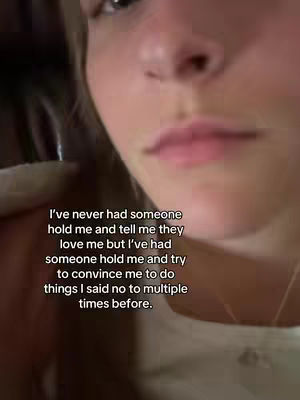 A close-up shot of a person's face, slightly out of focus with visible skin texture. The person's mouth and nose are the most prominent features. Overlayed text is visible at the bottom. The background is a blurred, dark color.