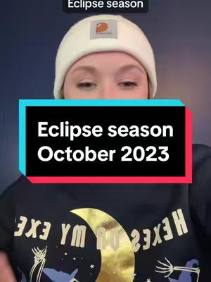 The cover image features a person wearing a cream beanie and a dark sweater emblazoned with a gold graphic. Overlay text in a rectangular box states 'Eclipse season October 2023'. The background is a gradient of deep blues and oranges.