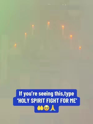 The image has a blurred background that transitions from green on the left to a lighter shade on the right. In the misty center, there are several lit candles, their flames appearing bright orange. Overlaying this serene scene is a blue box containing text asking the viewer to type "HOLY SPIRIT FIGHT FOR ME" if they're seeing it, with a few emojis below (praying hands, surprised face).