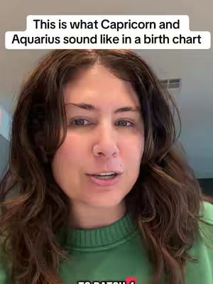 A selfie-style video cover image featuring a woman with long, wavy brown hair. She wears a green sweater and has a nose ring and a lip piercing. Above her head is a text overlay with white text on a black background.