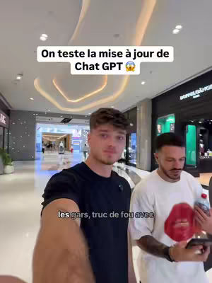 The cover image shows two young men indoors in a commercial setting, likely a shopping mall. The man in front is the main subject, looking at the camera. Overlayed text at the top in a white box reads "On teste la mise à jour de Chat GPT" indicating a testing of ChatGPT's update. The overall scene is brightly lit, with a modern design.