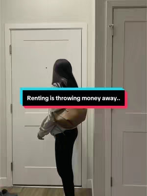 A person is standing in a hallway. They are wearing a light-colored hoodie, black leggings, and have a purse over their shoulder. The background includes two white doors and white walls. A text overlay in a colored box reads, "Renting is throwing money away.."