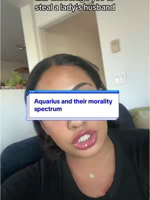 A woman with dark hair is shown in a close-up shot, with a text box overlay. The background is blurred, with a glimpse of a room visible.
