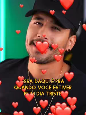 The cover image is a selfie-style shot of a man with a mustache and a black cap. He has a slight smile and several red heart emojis are overlaid around him, some appearing to come from his mouth. The background is a blurred green hue. Text overlaid in yellow is visible at the bottom.