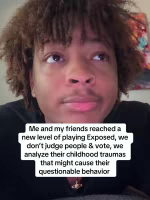 A medium shot of a young Black man's face, looking slightly upwards and to the right. He has short, curly dark hair. The background appears slightly blurred with indistinct colors, and a text overlay is placed below the man's face, written in a white font within a black rectangle. He has a light complexion and a neutral expression, with subtly parted lips and a slight shadow under his eyes