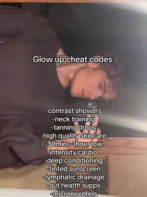 The image is a selfie-style shot, likely from a phone, with a person in it appearing from the right of the image. The person is fair-skinned and appears to be of a young age, around their 20s. The image is shot in a vertical format, and the person's face is partially visible. The background features a dark setting. The image has text overlayed on top of it. 