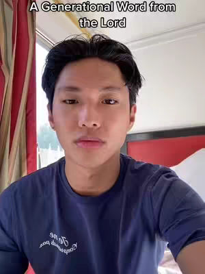 A young man with dark hair and a blue t-shirt is centered in the frame, giving a direct gaze to the camera. A text overlay at the top reads, 'A Generational Word from the Lord'. The background includes glimpses of a window with sunlight and red curtains.