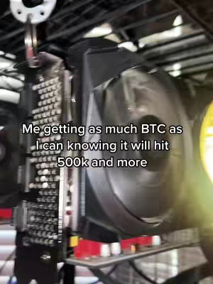 The cover image features a close-up view of a computer component, likely a graphics card, possibly involved in cryptocurrency mining. The card is black and grey with a large fan visible. Overlaid text provides context about bitcoin.