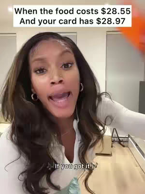 A woman with flowing brown hair, wearing a white top, is expressing herself with an open mouth, the top text says, "When the food costs $28.55 and your card has $28.97", and the bottom text says, "If you got it".