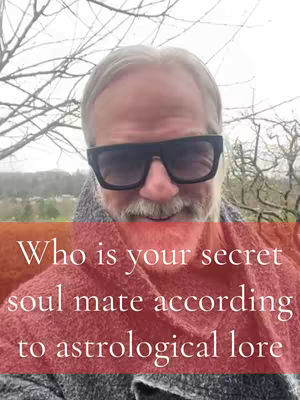 The cover image shows a man wearing sunglasses, with a text overlay over the lower portion. The man seems to be outdoors with bare tree branches visible in the background. The text overlay is on a red background and reads: 'Who is your secret soul mate according to astrological lore'.