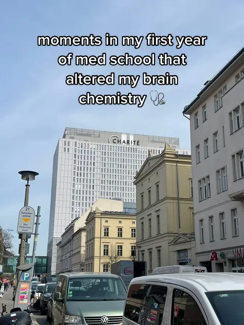 A street view with a clear sky, featuring buildings of various heights and architectural styles. The foreground includes parked vehicles, a parking sign, and people walking on the sidewalk. The text overlay highlights the topic of the video.