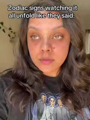 A close-up shot of a woman with brown eyes and long, wavy brown hair. She has a neutral expression, with text overlaid on the upper portion of the image.