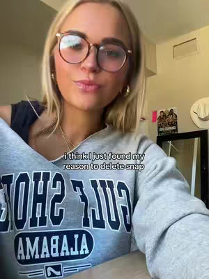 A young woman wearing glasses and a gray sweatshirt is looking at the camera, with text overlayed at the bottom that says, "i think i just found my reason to delete snap."