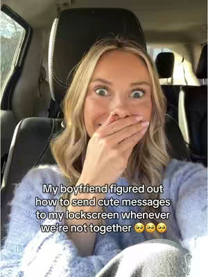A selfie of a blonde woman in a car looking at the camera with a surprised expression. She has her hand over her mouth. Text overlays the image.